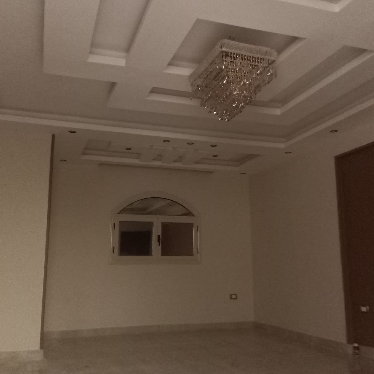 سقف جبس بورد متعدد الطبقات بتكوين مستطيل ونجفة مركزية داخل فيلا
